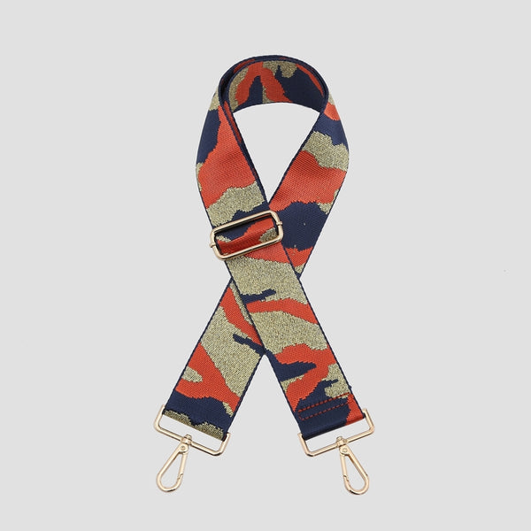 An adjustable bag strap with a navy blue, orange and gold camouflage pattern.