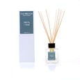 A home fragrance diffuser with a wild fig scent. White box packaging. Product shows a glass bottle with reed diffuser sticks.